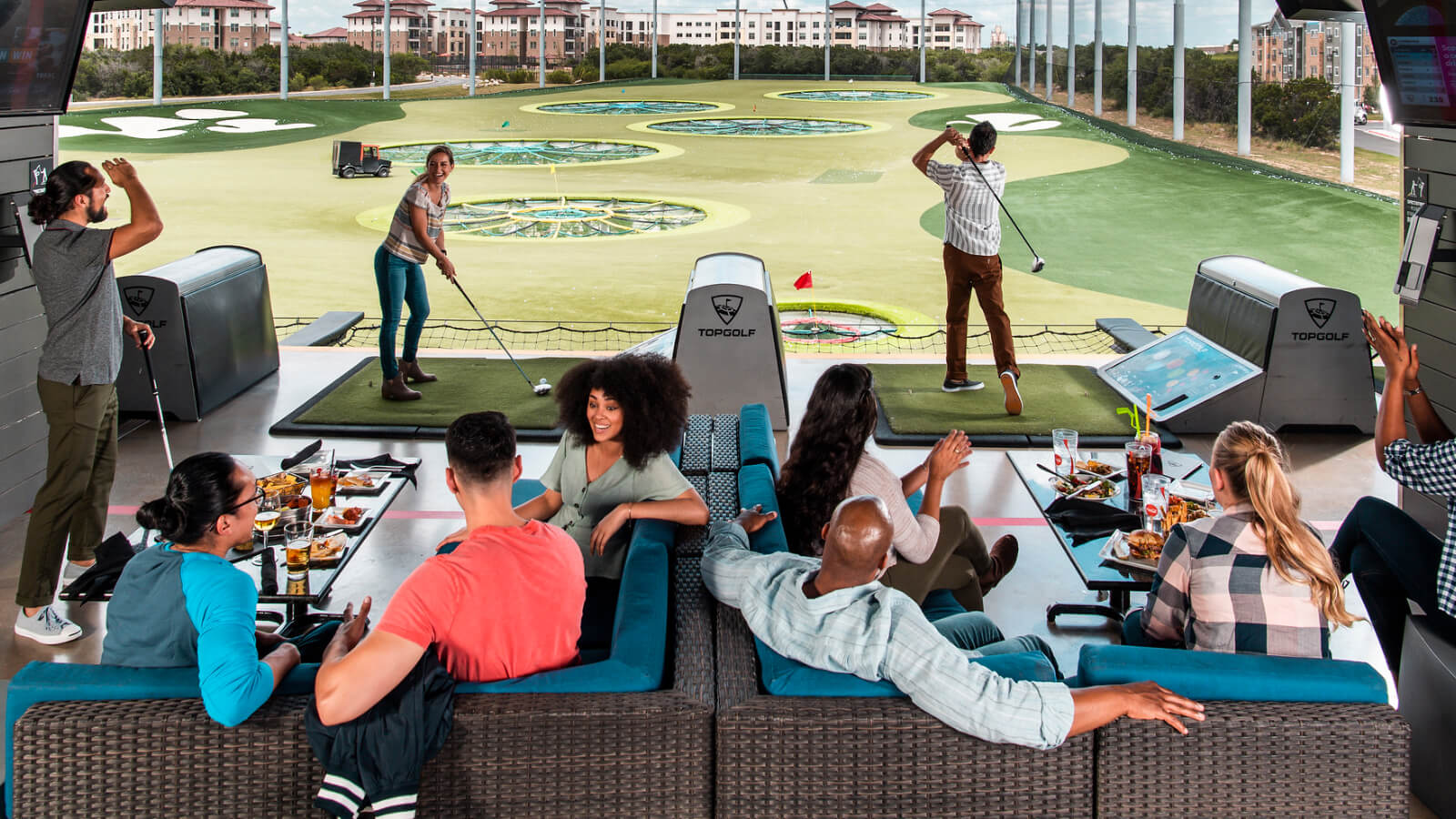 Group inside a bay at Topgolf