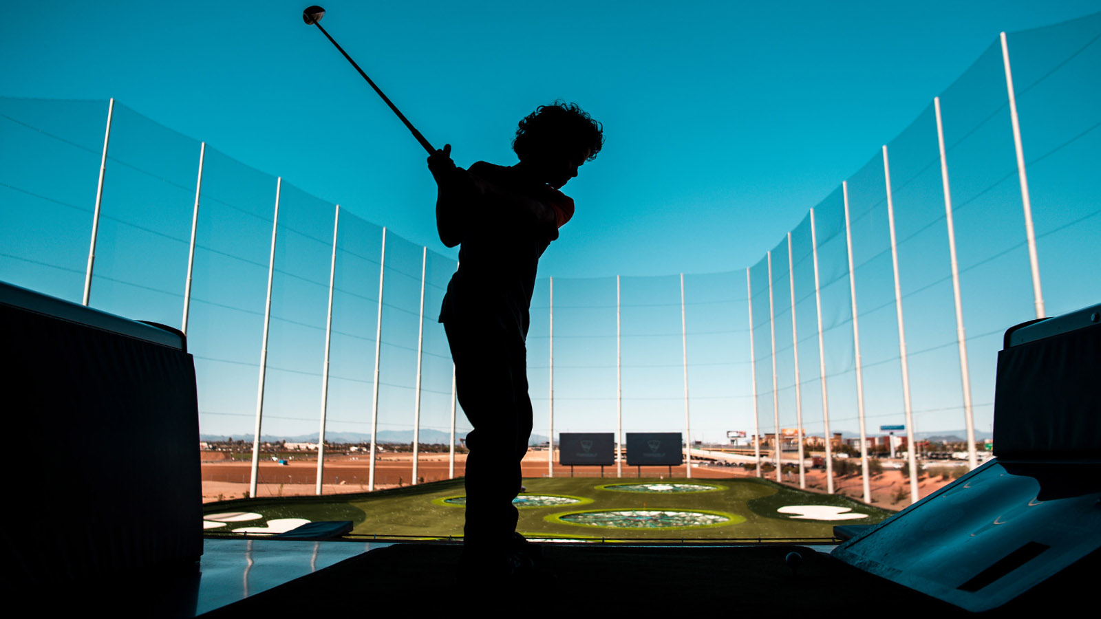 Young player hitting a ball at Topgolf