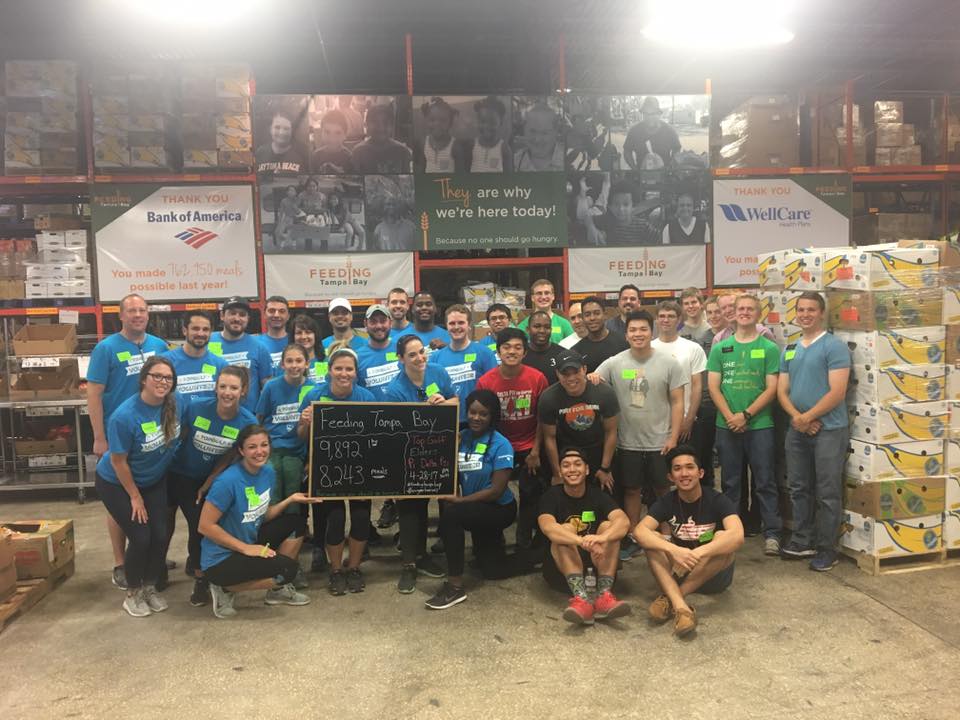 Topgolf employees voluteering at a food bank