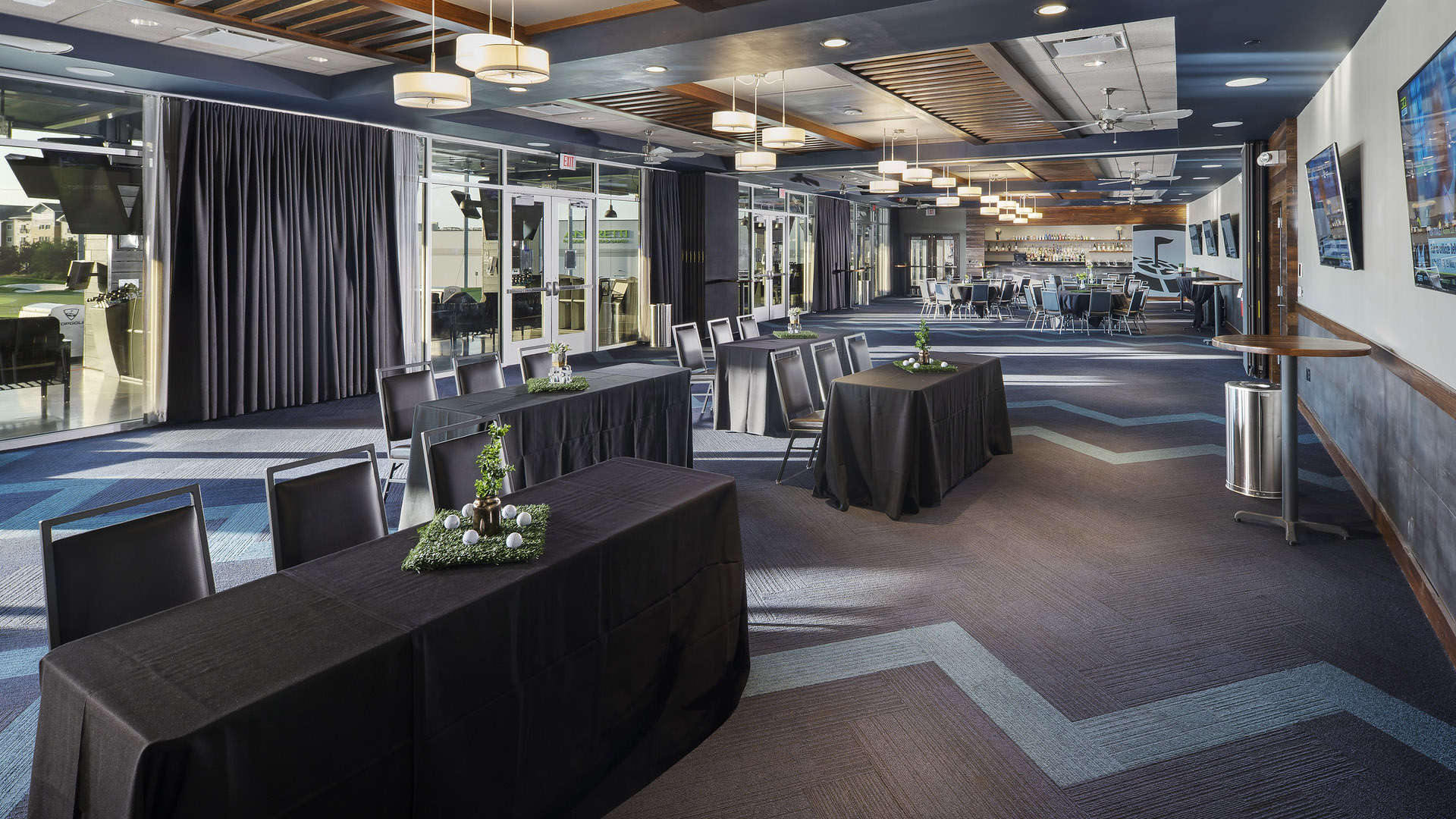 Events space set up for a presentation at Topgolf